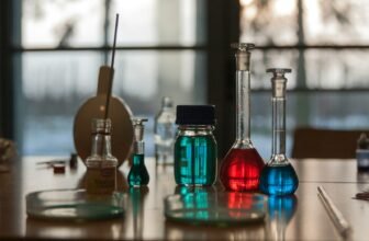 A table topped with flasks filled with liquid