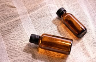 two small brown bottles sitting on top of a table, chemistry of poison